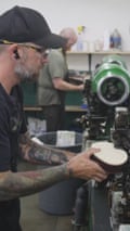 A worker sews a boot.