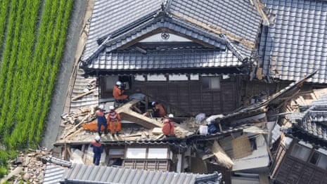 'People are waiting to be rescued': race under way to find Japan quake survivors – video