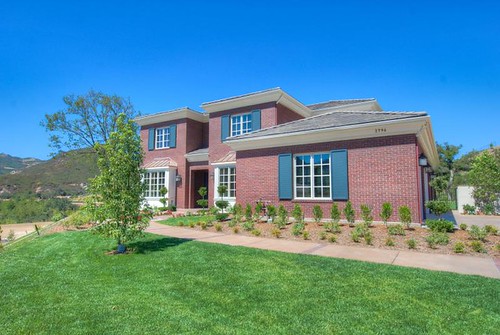 Suburban brick home with manicured lawn, used to illustrate property tax assessment appeals