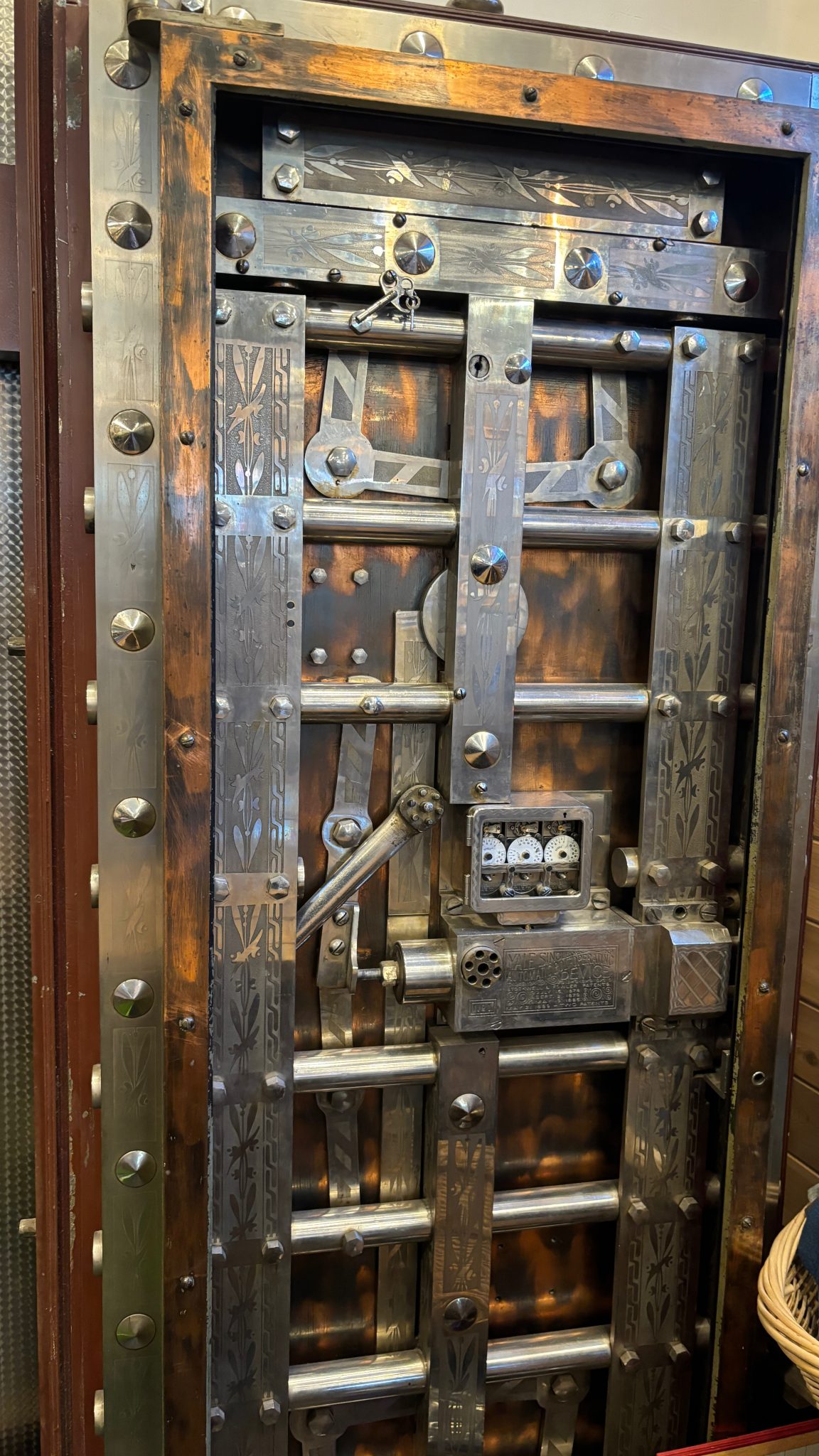 Ornate vintage bank vault door with heavy bolts, keys and locking mechanism visible, representing a frozen or restricted bank account